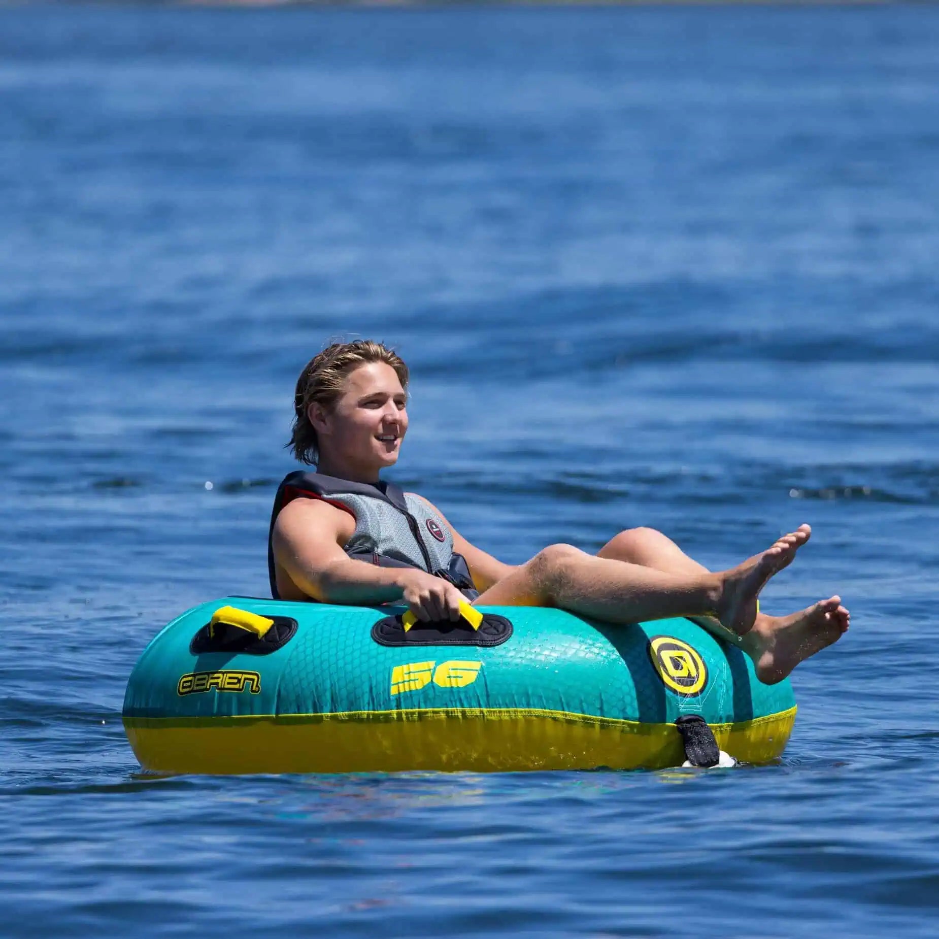 a person sitting on the O'Brien Le Tube Towable Boat Tube, enjoying the water