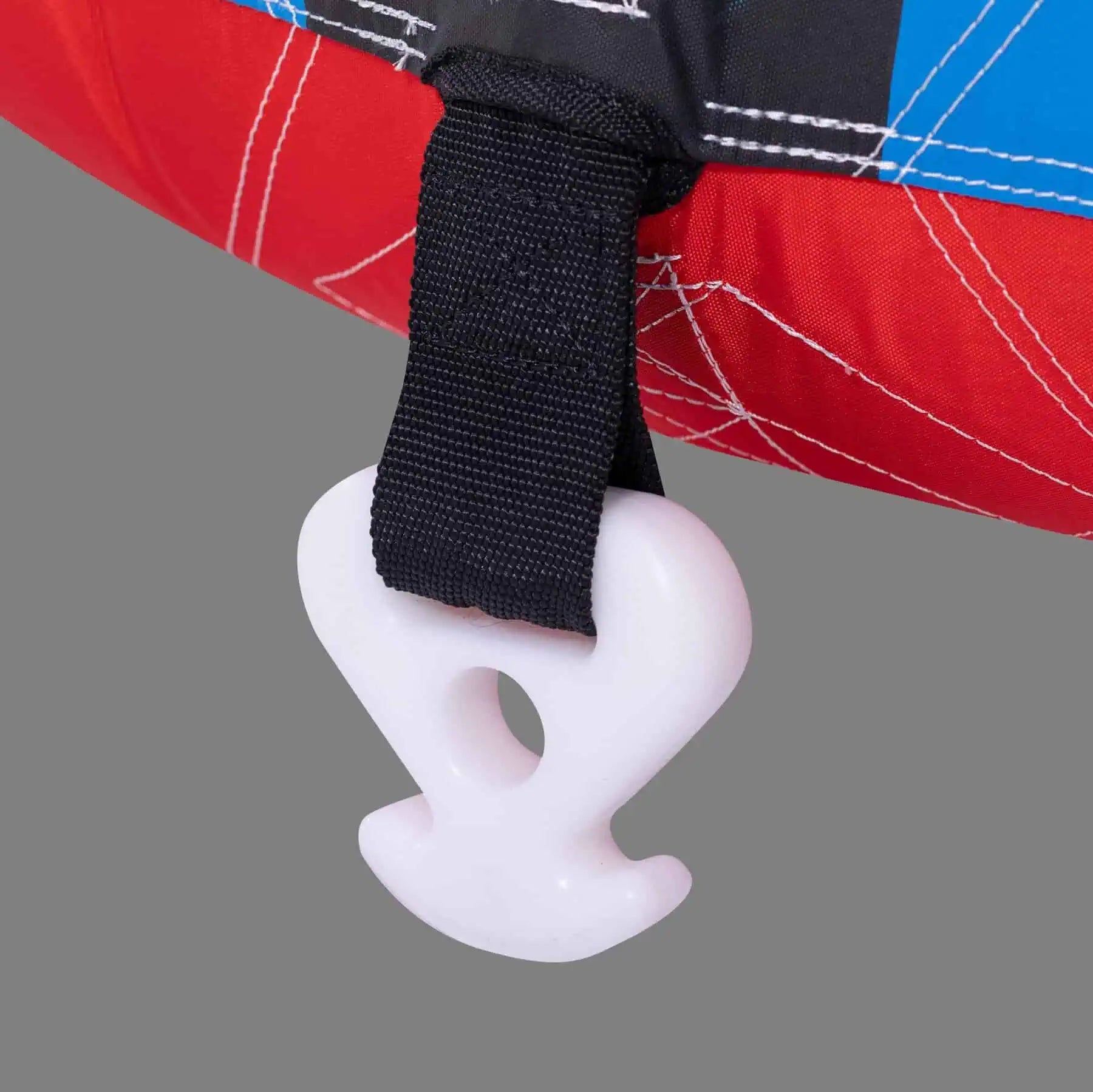 Close-up of a white plastic hook attached to a red and blue fabric with a black strap. O'Brien Screamer Tube