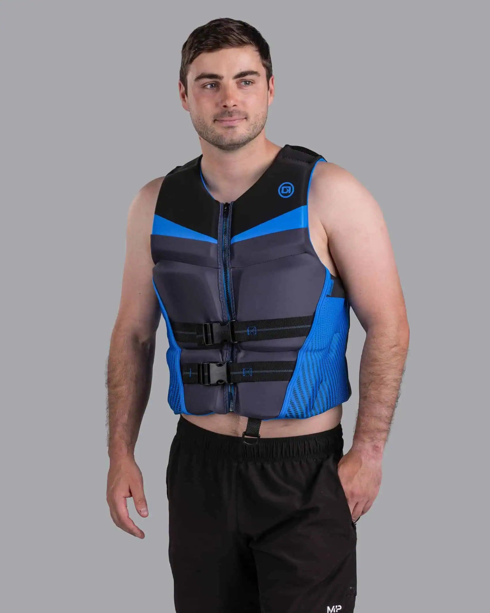 Man wearing a black and blue O'Brien Men's Flex V-Back Life Jacket