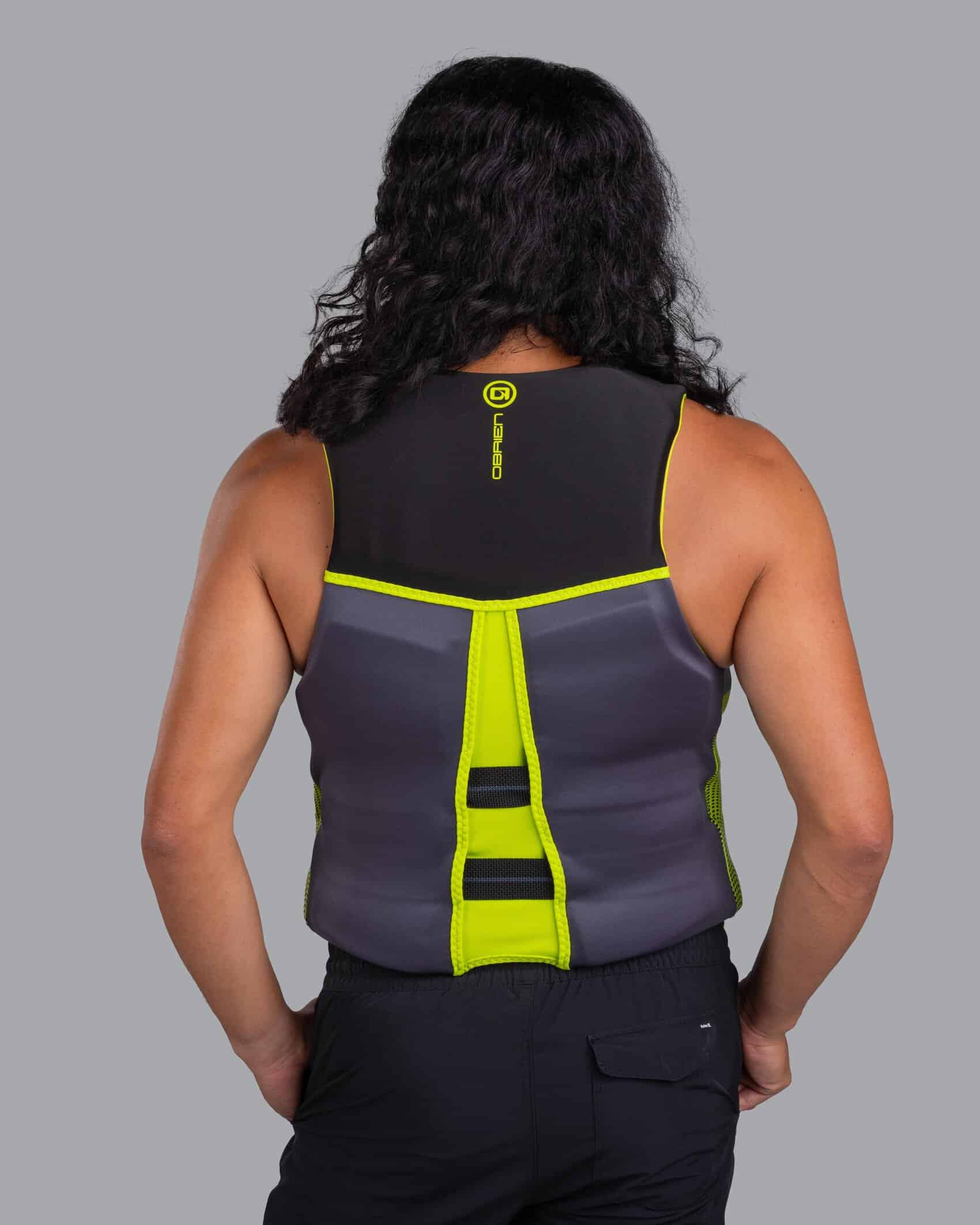 Person wearing a green O'Brien Men's Flex V-Back Life Jacket