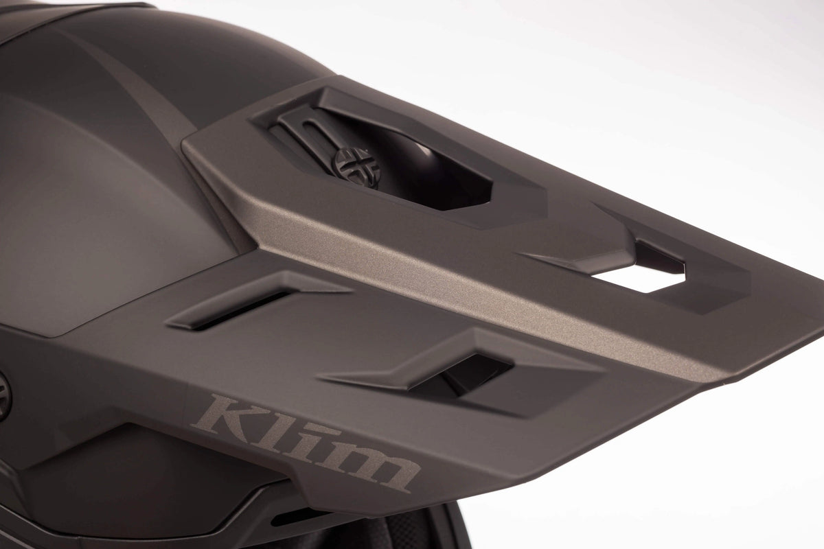 visor detail on the solid matte black Klim T1 Freeride ECE Youth Snowmobile Helmet