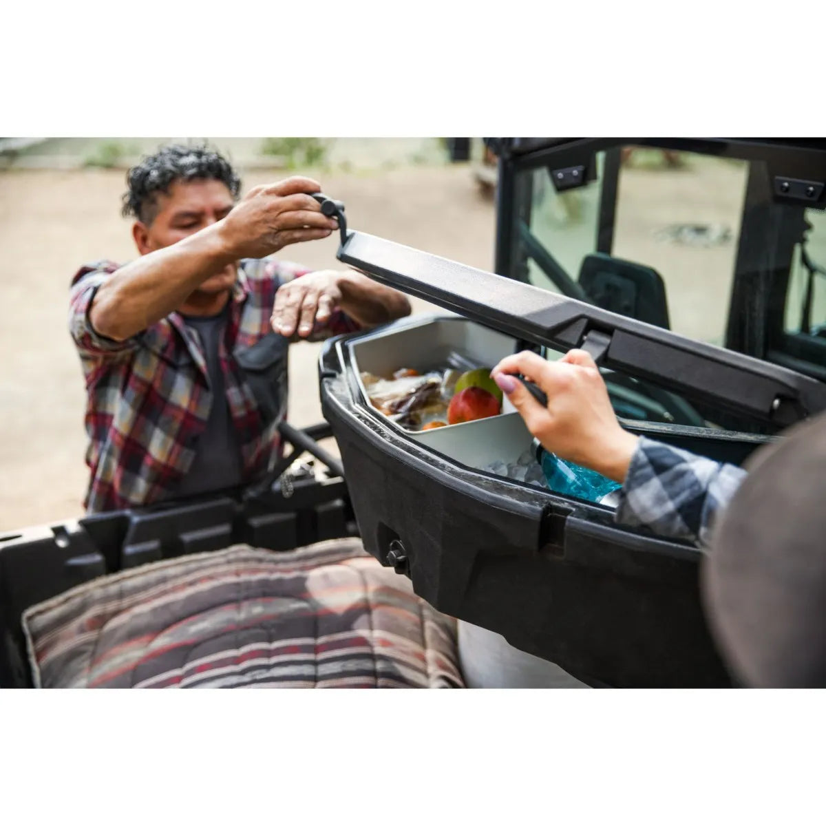 opening the Can-Am LinQ Cargo Box - 45 L to reveal many stored items