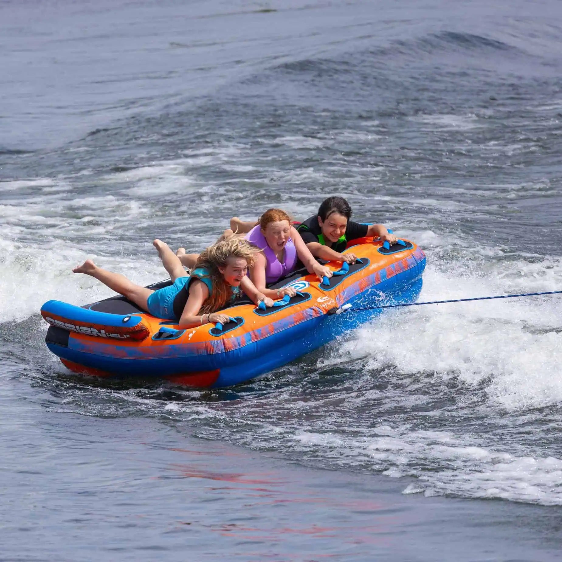 three kids riding the O'Brien Heli 3 Boat Tube