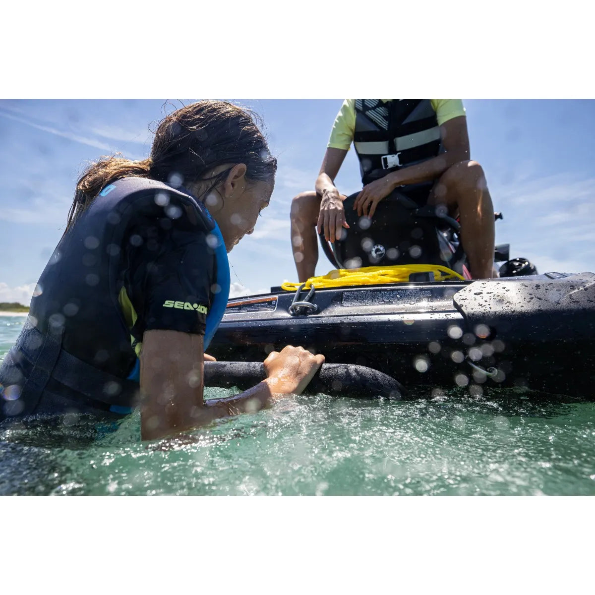 a young woman grips onto the Sea-Doo Boarding Ladder