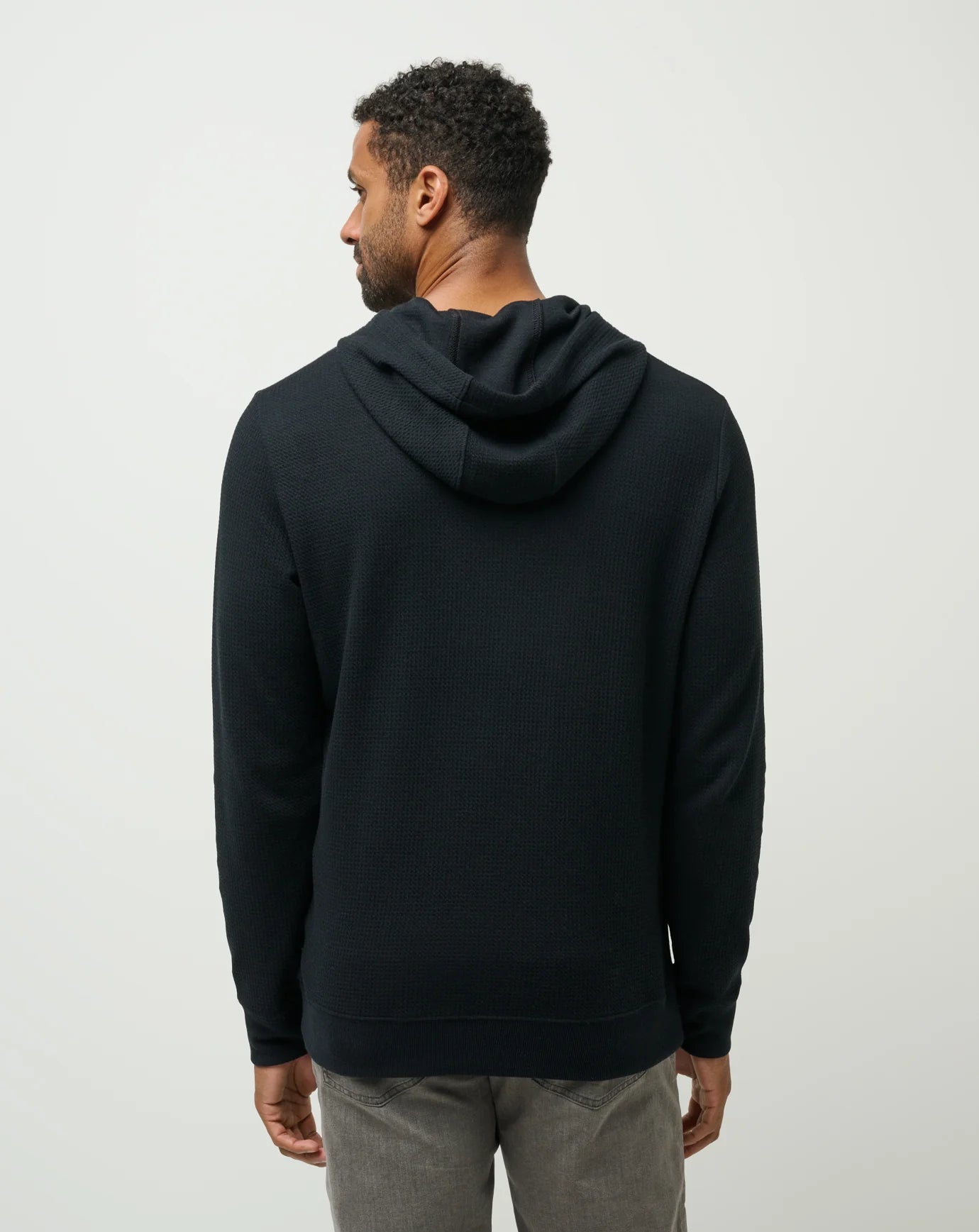back view of black TravisMathew Cloud Waffle Hoodie