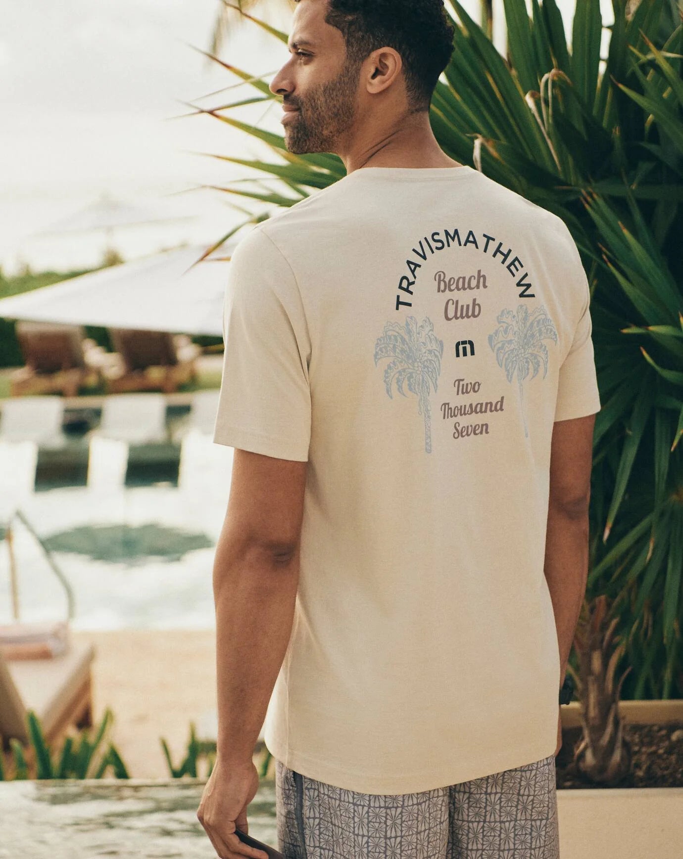 a man outside wearing the TravisMathew Club Member T-Shirt