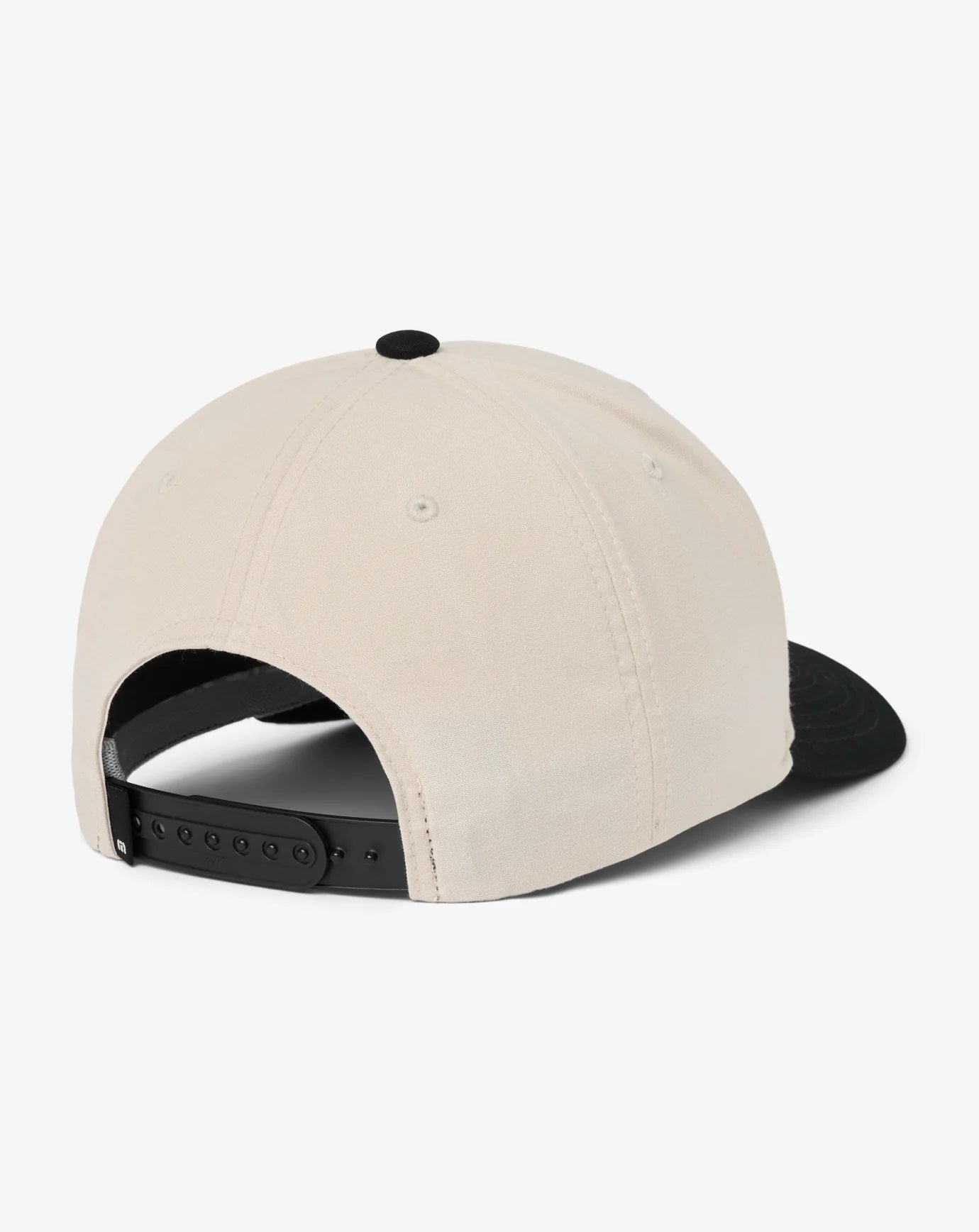 Beige and black TravisMathew cap on a white background