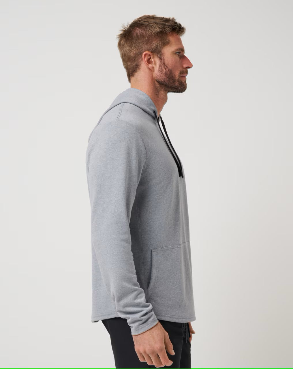 side view of the heather grey TravisMathew Upgraded Tech Hoodie