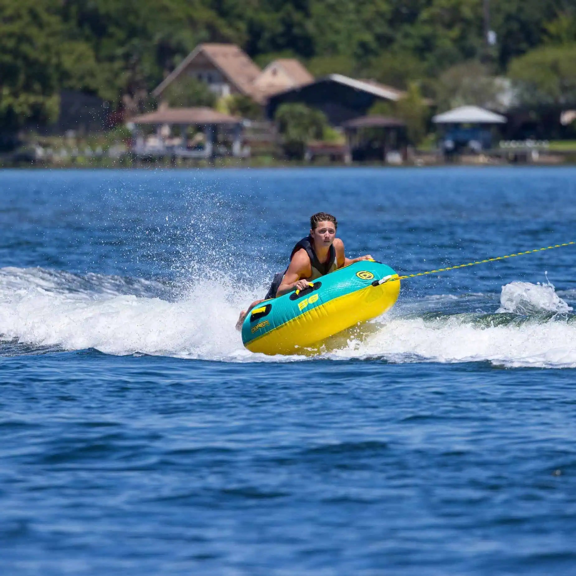 a person is riding on the O'Brien Le Tube Towable Boat Tube on the water