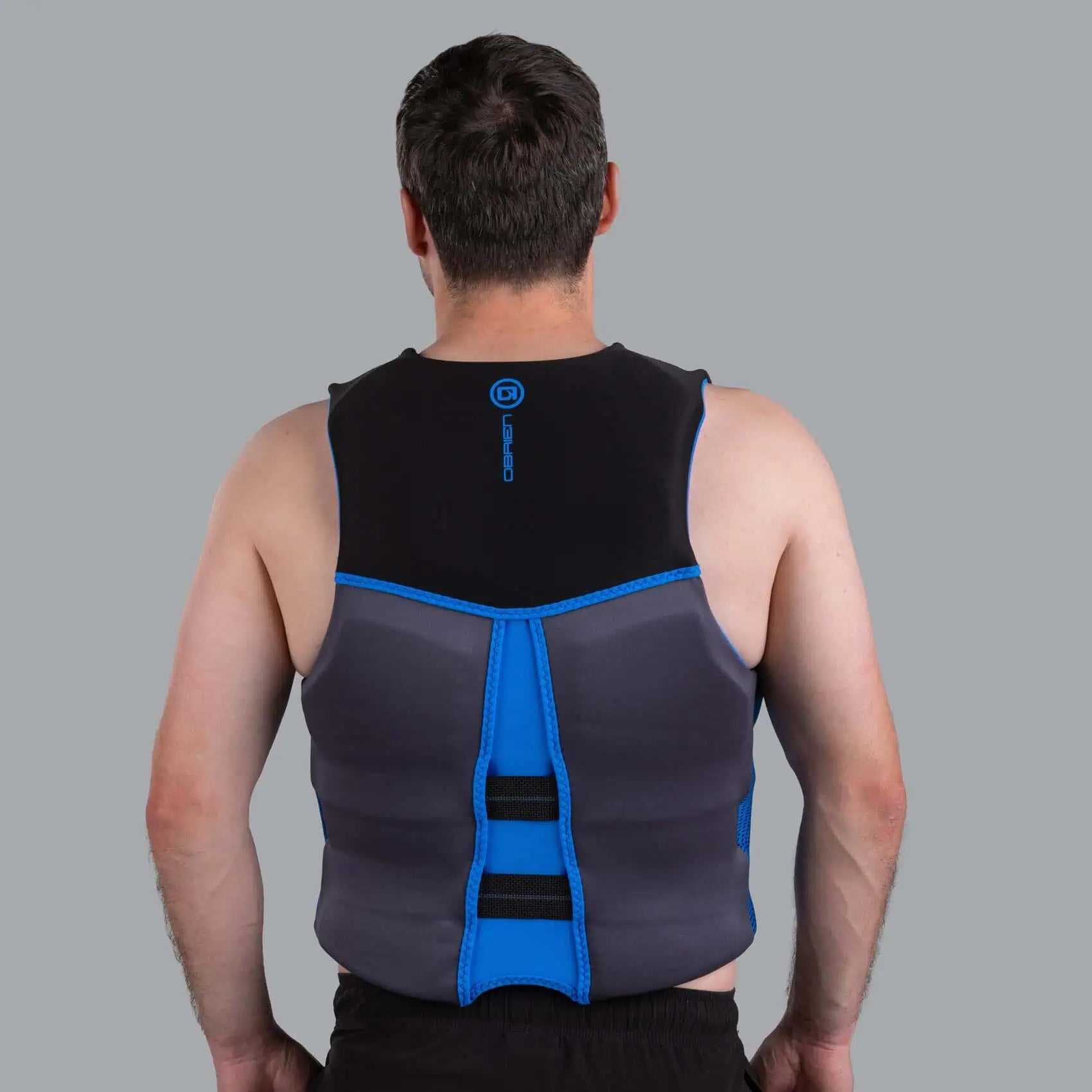 Person wearing a blue O'Brien Men's Flex V-Back Life Jacket
