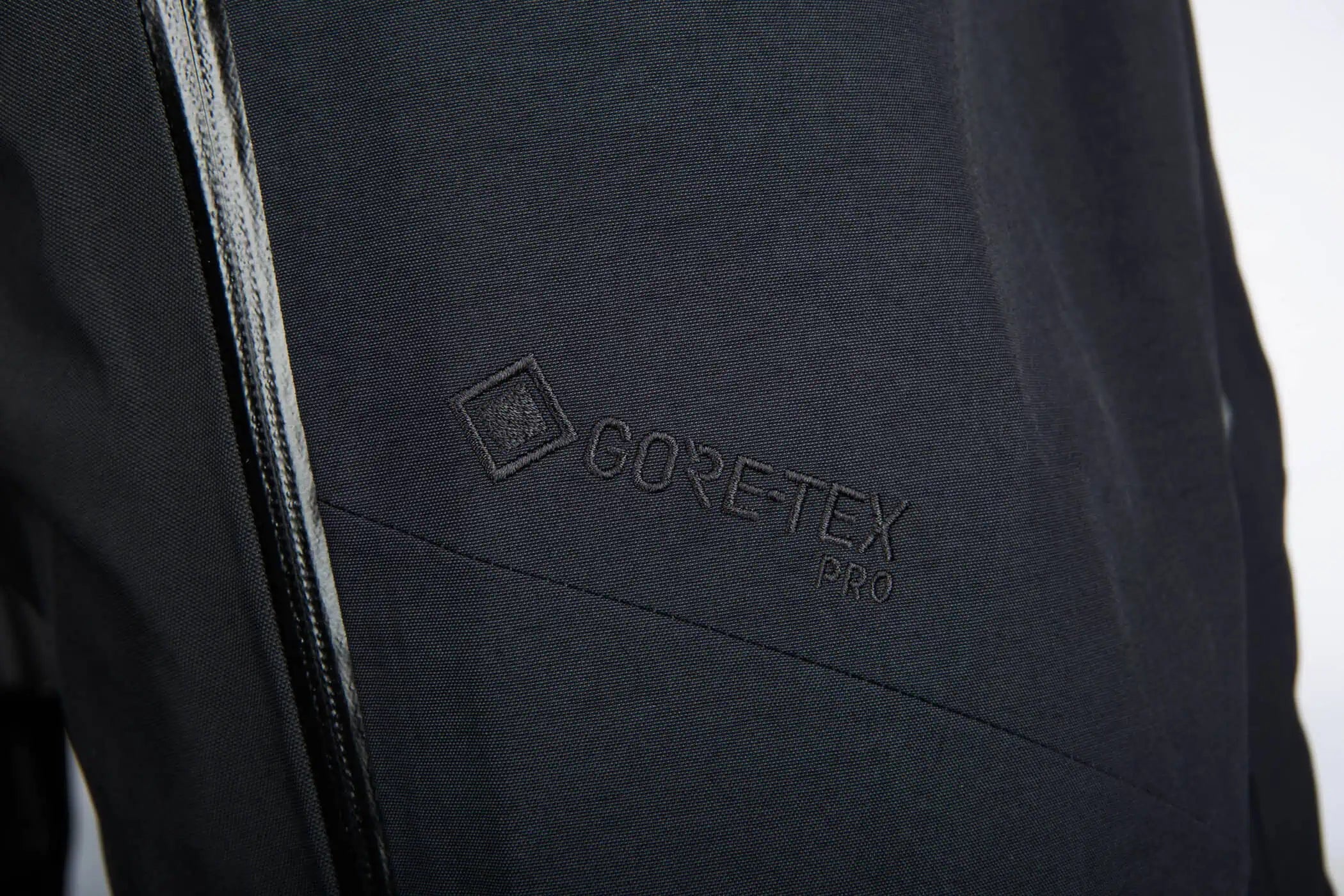 Close-up of a Klim Togwotee Bib with a black zipper and an embossed GORE-TEX PRO logo on the chest.
