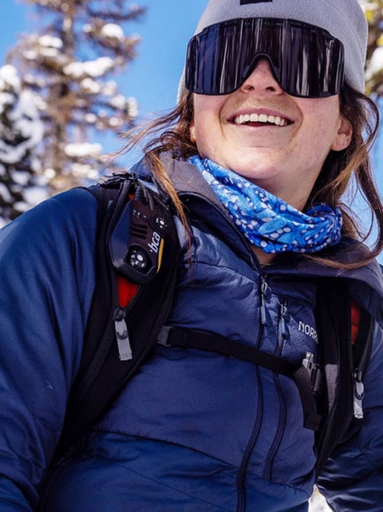 Person wearing a blue jacket and goggles with a BCA BC Link Two-Way Radio 2.0