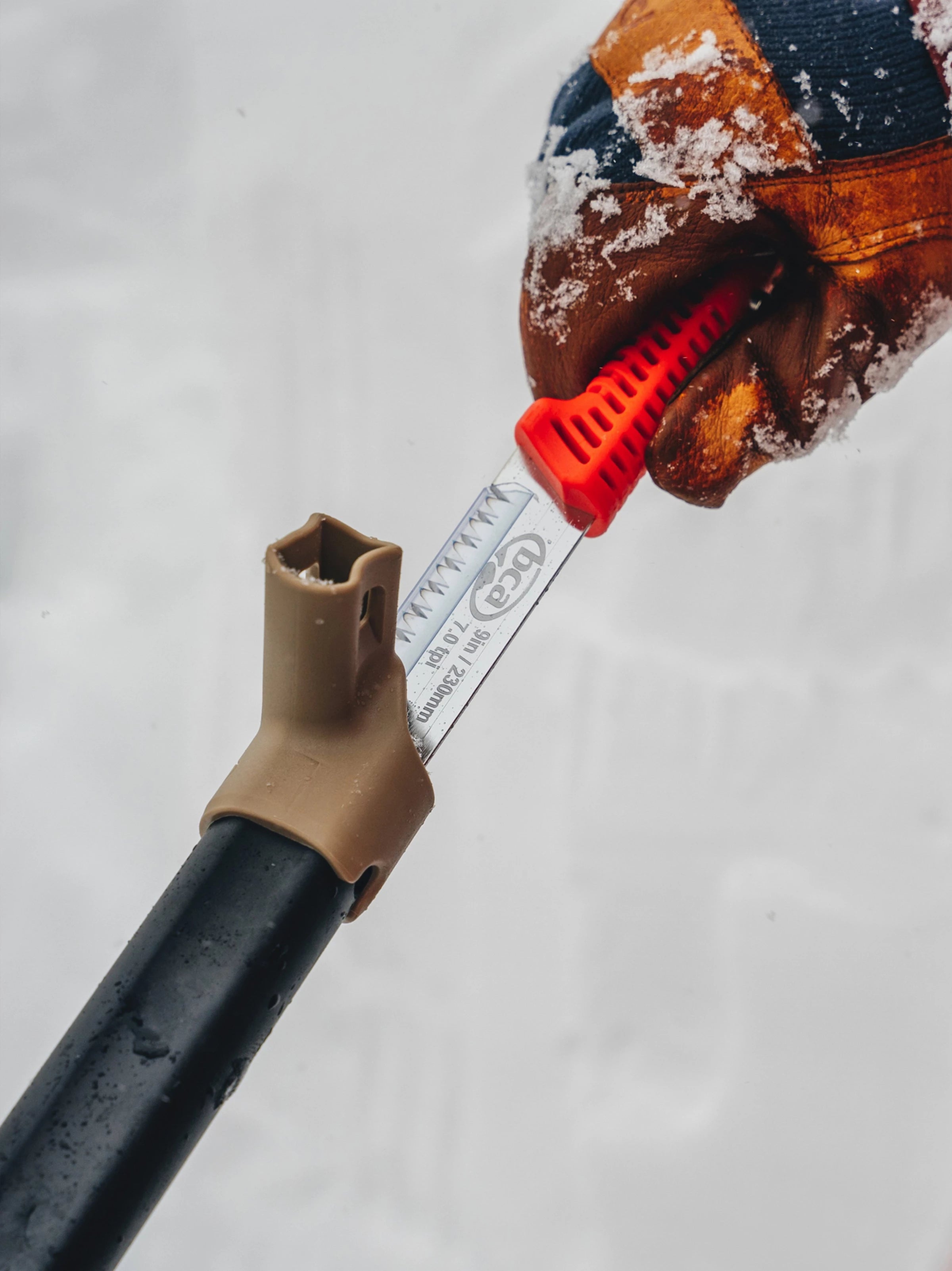 the saw blade being pulled out of the BCA Dozer™ 2T-S Avalanche Shovel