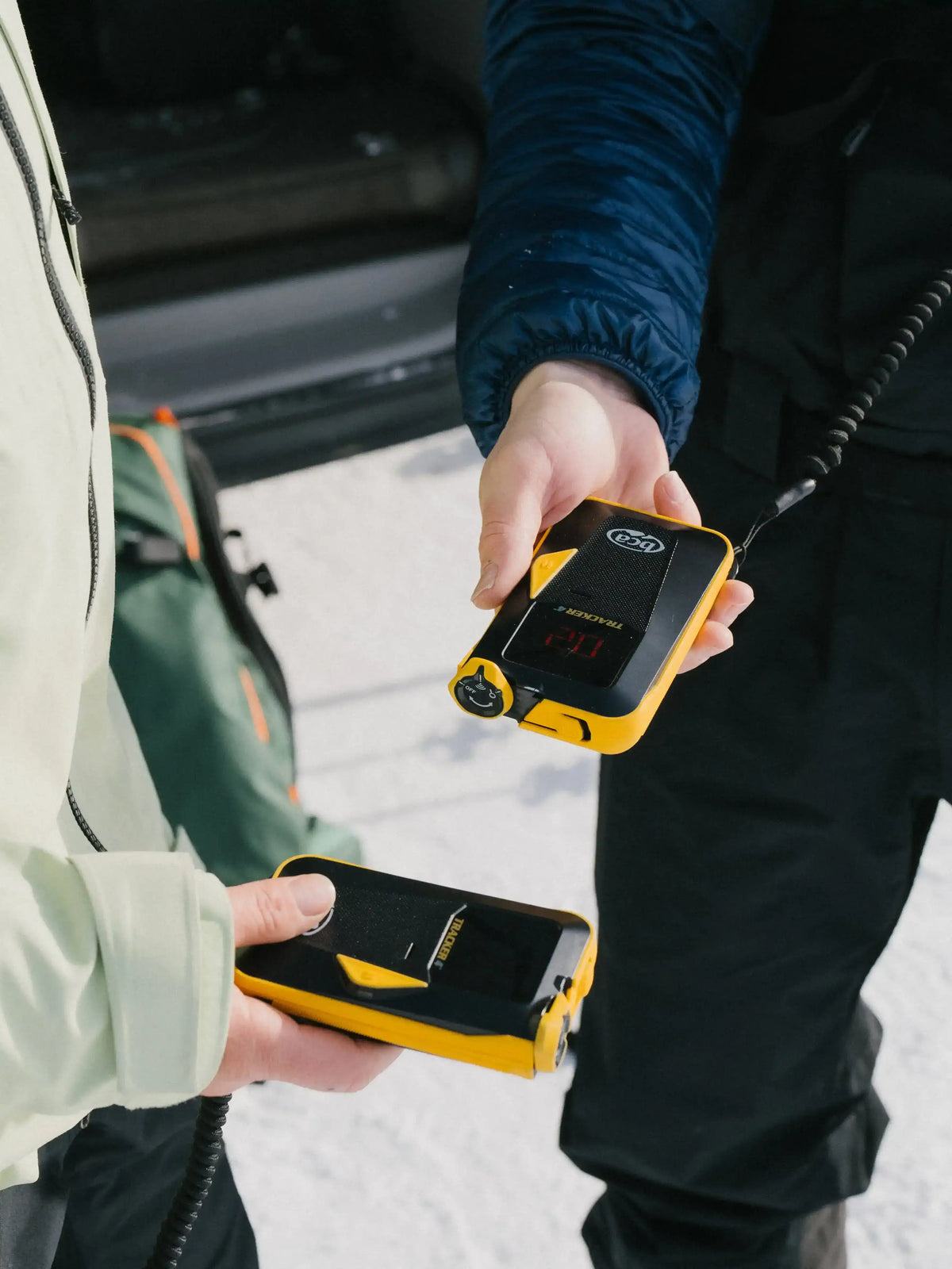 two people holding the BCA Tracker4 Avalanche Transceiver