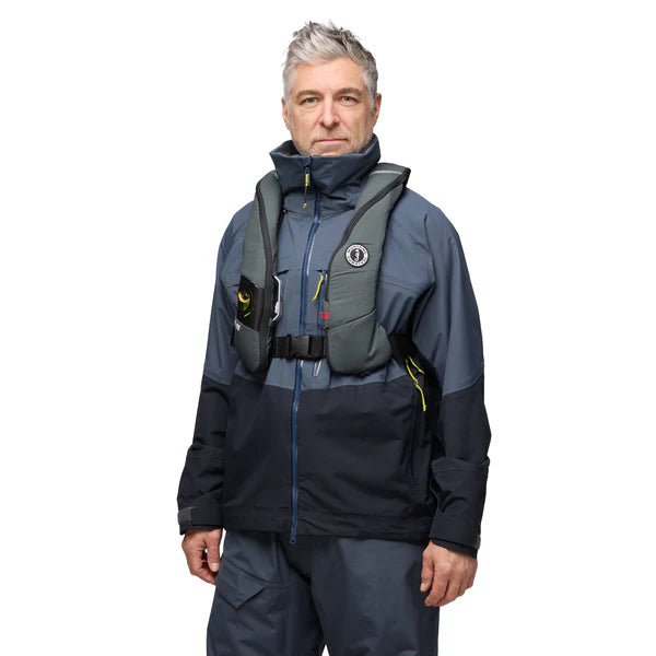 a man wearing the admiral grey Mustang Survival Elite 120 Inflatable PFD