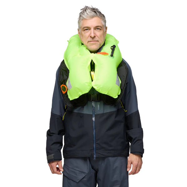 a man wearing inflated version of the admiral grey Mustang Survival Elite 120 Inflatable PFD