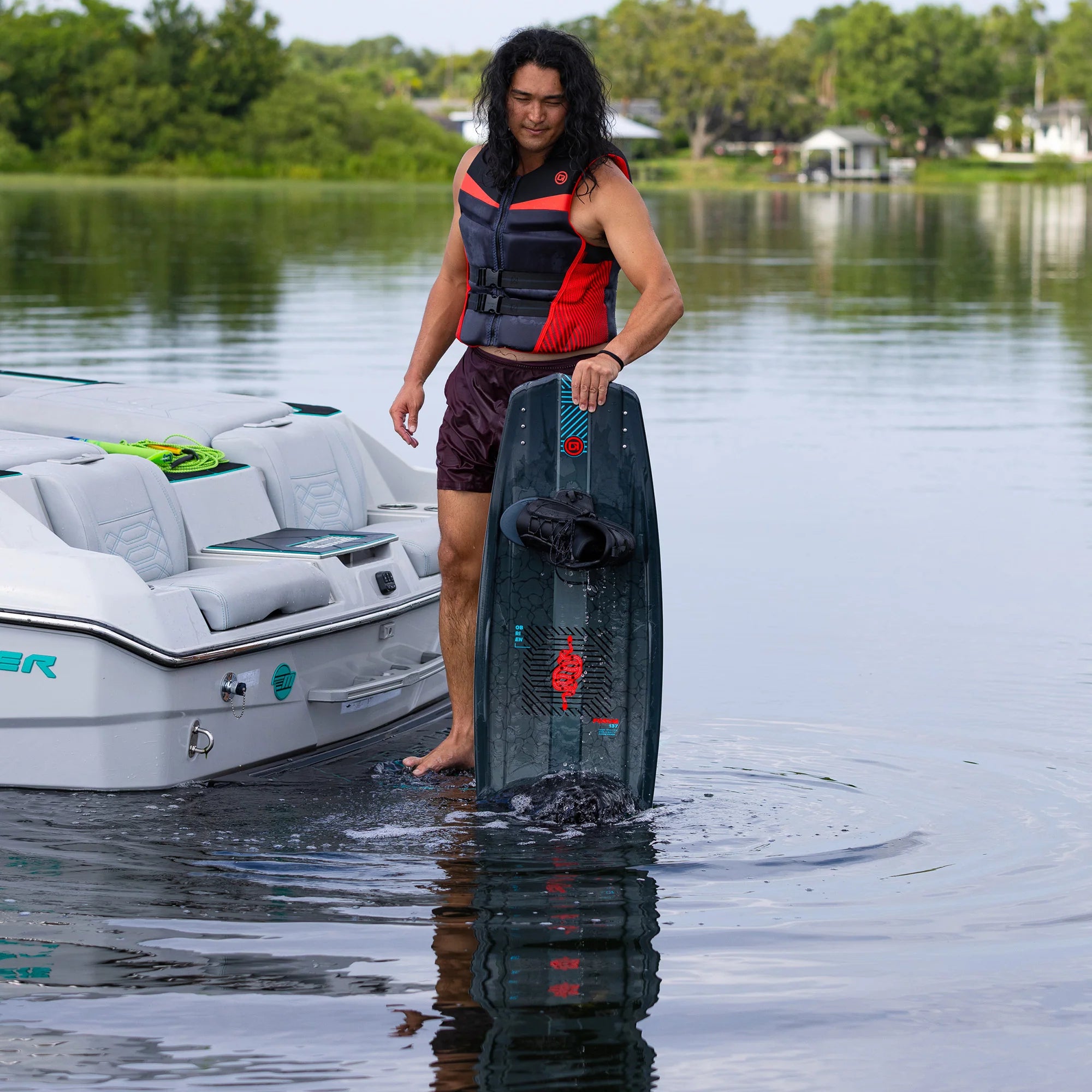 a man is holding the O'Brien Forum Wakeboard in the water