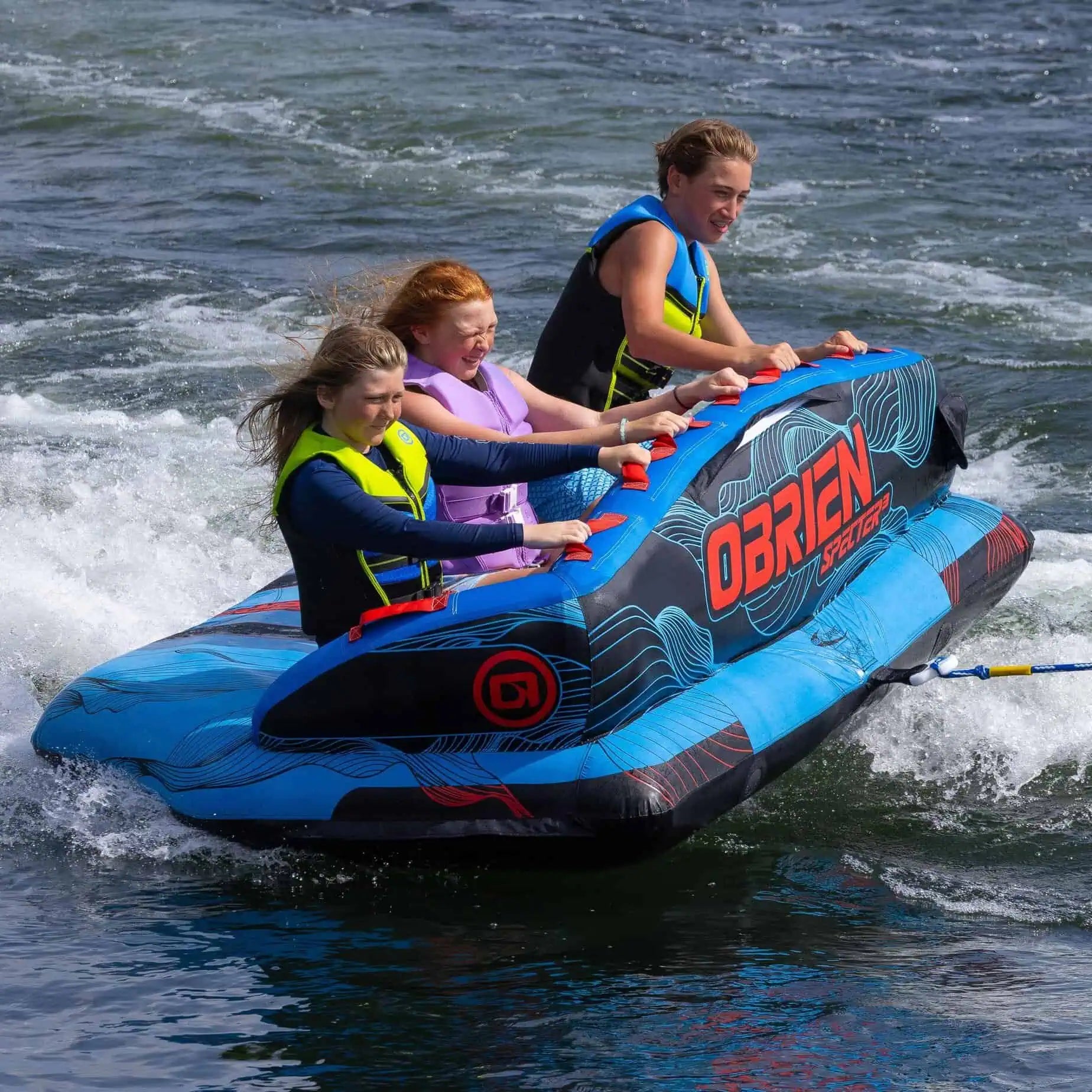 Three people on an inflatable O'Brien Specter 3 Boat Tube in the water