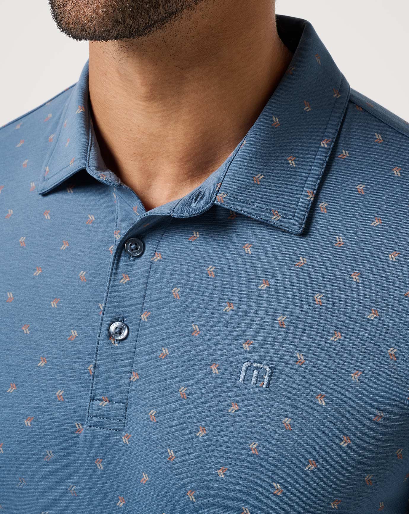 front detail of the TravisMathew Performance Jersey Resort Polo Shirt