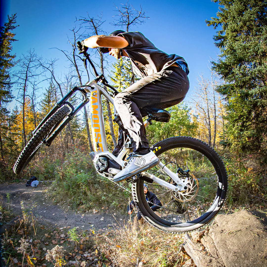 a person jumping with the Vamoose Matador FS Downhill E-Bike