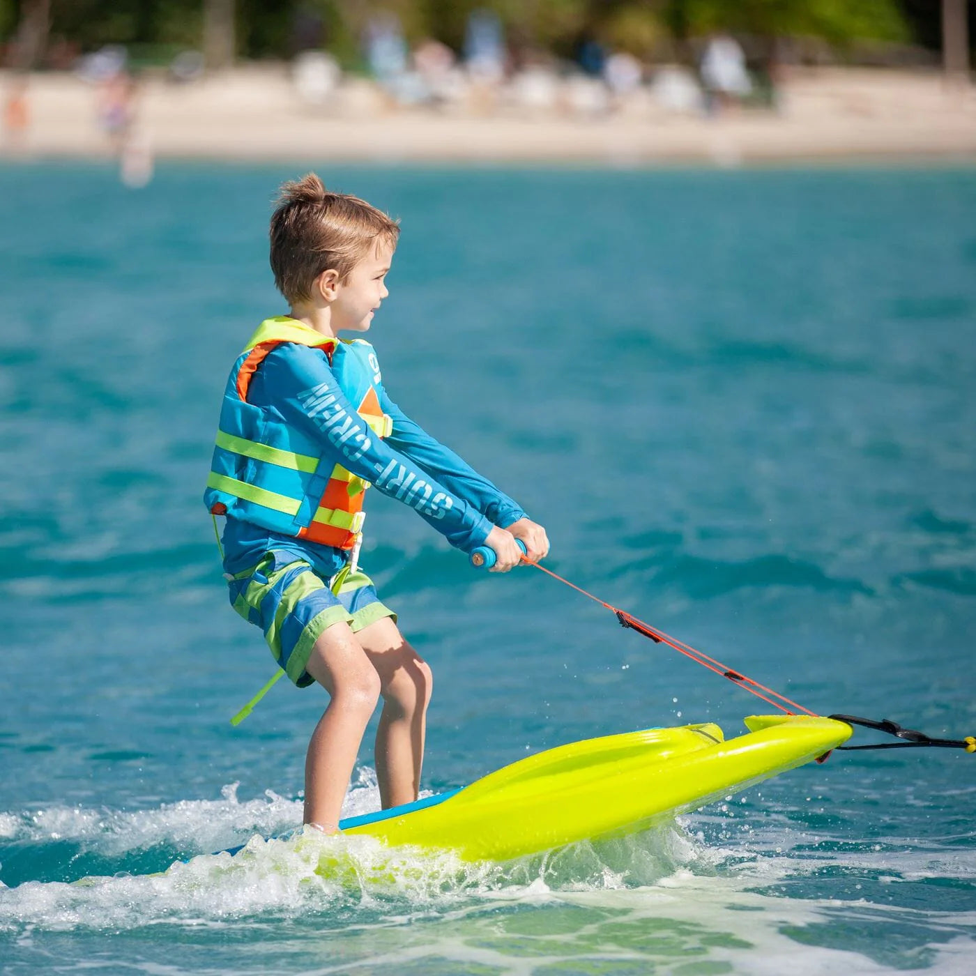 Child on the ZUP Coast 80 Multi-Sport Board for Kids on a sunny day at the beach